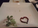 Empty sushi plate, before I bit into the heart! 