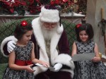 Santa with the girls talking about their lists.