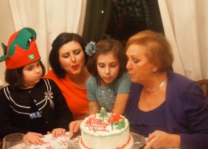 My mom and I with my girls blowing the candles out