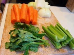 The vegetables: 2 medium yellow onions quartered, 4 carrots cut in half, and 4 organic celery stalks halved with leaves kept whole.