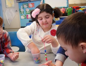 Making her bracelet with friends.