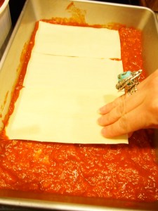 Add one layer of the pasta over the sauce