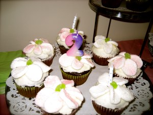 Cupcakes with Marshmallow flowers and green maraschino cherry centers