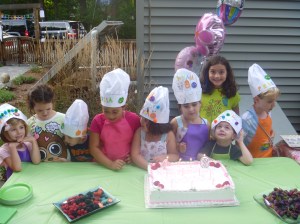 Some of the kids together in their hats and aprons