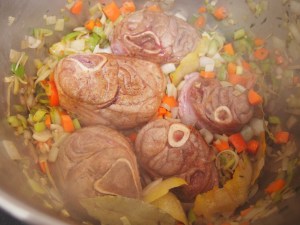 Once vegetables are aromatic and colorful add in the browned osso buco