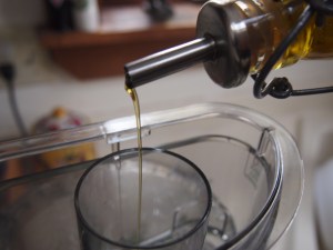 While the food processor is on, drizzle in olive oil