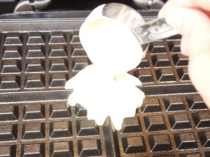 Start pouring batter in the center of the heated waffle iron.