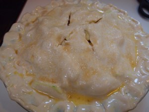 Egg wash the whole top, then sprinkle on 1 tbsp of raw sugar and cut vent slices on top of the dough. 