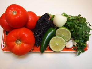 All you need is..fresh tomatoes, jalapeno pepper, lime juice, fresh cilantro, onion and an Ancho Chile.  AND A FOOD PROCESSOR!
