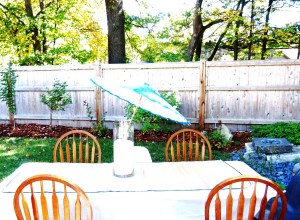 Decor outside, the rice filled vases with a paper parasol embedded, all on top of a table dressed with a wooden woven mat.