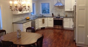 THE KITCHEN AFTER-  I am standing exactly where the photo above shows the wall with the door opening in the old dining room.  Amazing right? Ok except the old table!  Don't look at that!